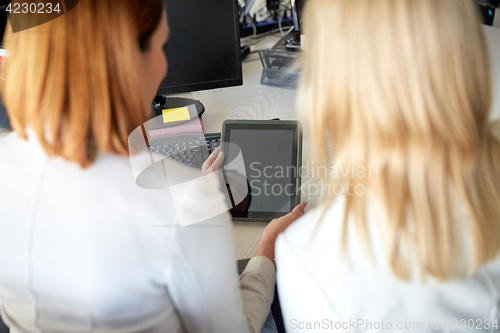 Image of businesswomen with tablet pc computer at office
