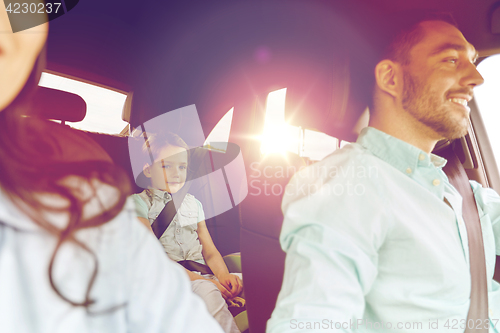 Image of happy family with little child driving in car