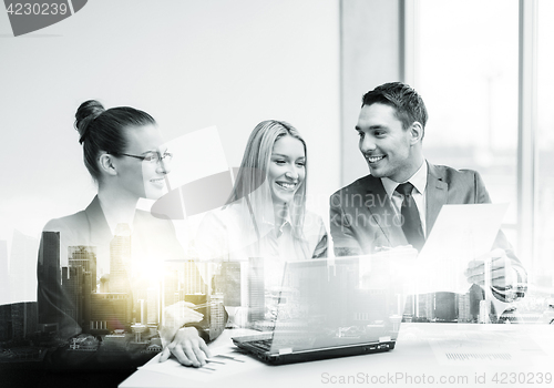 Image of business team with laptop having meeting at office