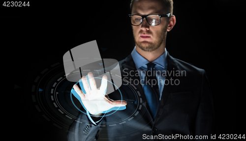 Image of businessman touching virtual screen projection