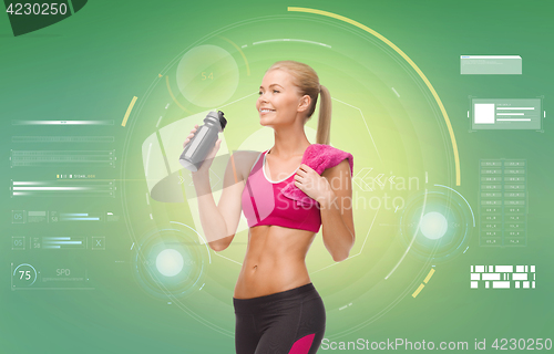 Image of sporty woman with bottle of water and towel