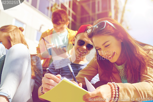 Image of group of students with notebooks at school yard