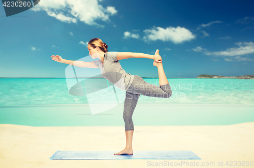 Image of woman making yoga in lord of the dance pose 