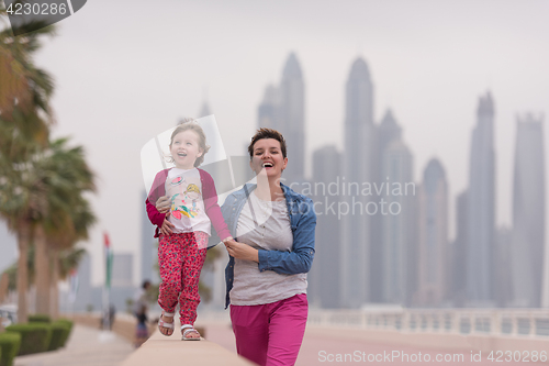 Image of mother and cute little girl on the promenade