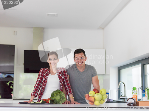 Image of Young handsome couple in the kitchen