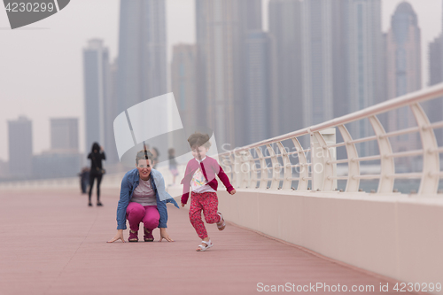 Image of mother and cute little girl on the promenade