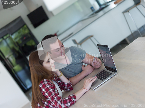 Image of happy young couple buying online