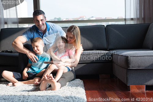 Image of happy young couple spending time with kids