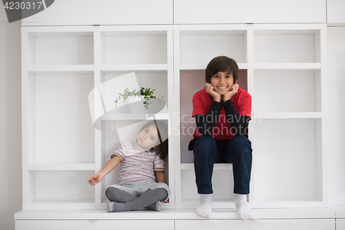 Image of young boys posing on a shelf