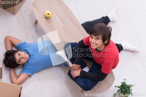 Image of boys with cardboard boxes around them top view