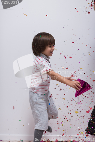 Image of kid blowing confetti