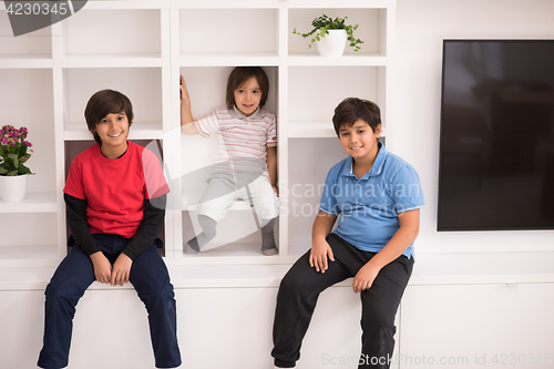 Image of young boys posing on a shelf