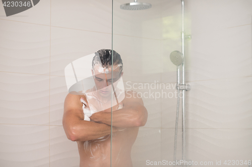 Image of man taking shower in bath