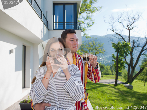 Image of Young beautiful couple in bathrobes