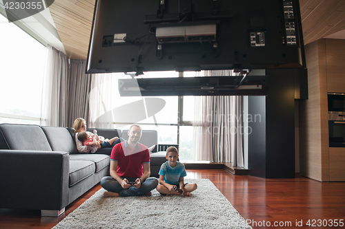 Image of Happy family playing a video game