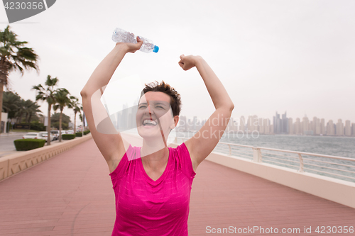 Image of young woman celebrating a successful training run