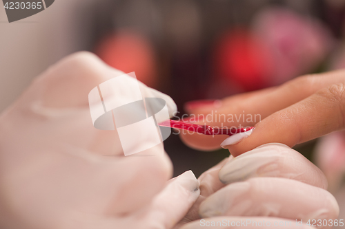 Image of Woman hands receiving a manicure