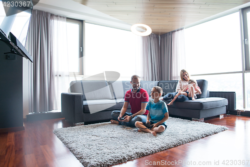 Image of Happy family playing a video game