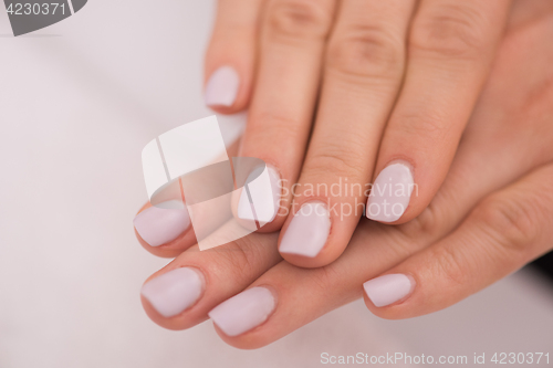 Image of woman fingers with french manicure