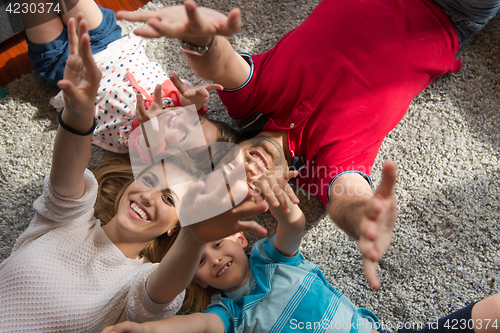 Image of happy family lying on the floor