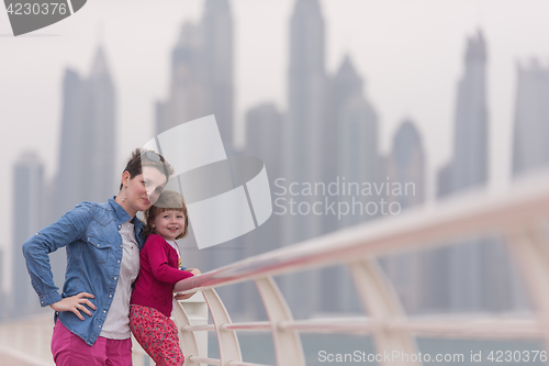 Image of mother and cute little girl on the promenade