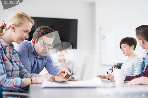 Image of Two Business People Working With laptop in office