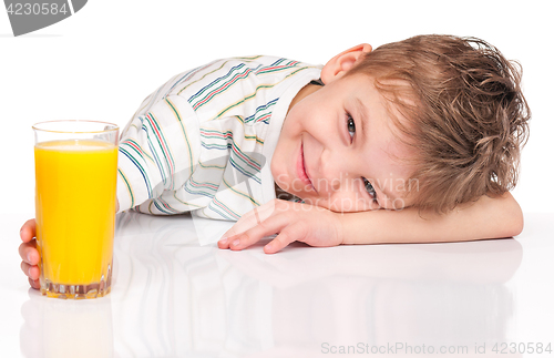 Image of Little boy drinking orange juice