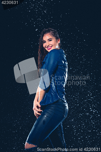 Image of Young beautiful woman under splash of rain