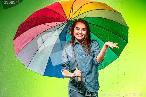Image of Young beautiful woman with an umbrella.