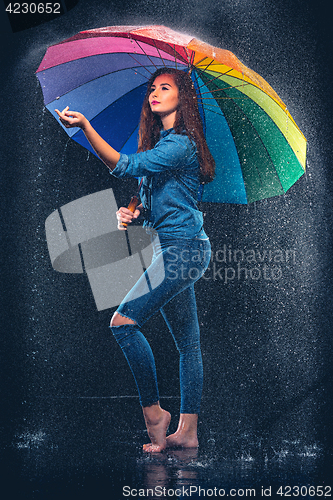 Image of Young beautiful woman with an umbrella.
