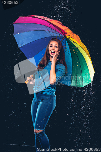 Image of Young beautiful woman with an umbrella.