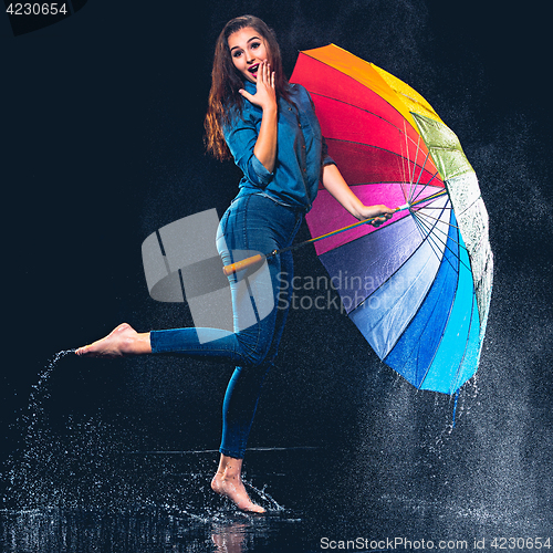 Image of Young beautiful woman with an umbrella.