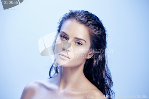 Image of Beautiful woman face portrait close up on blue