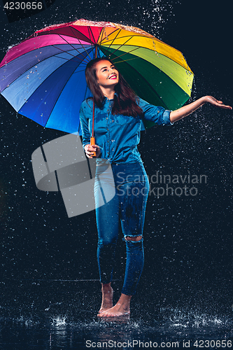 Image of Young beautiful woman with an umbrella.