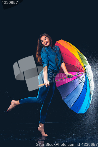 Image of Young beautiful woman with an umbrella.