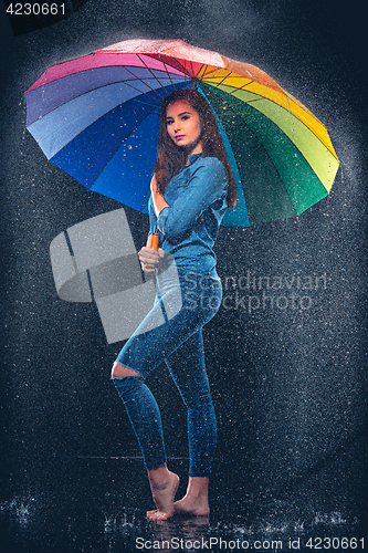 Image of Young beautiful woman with an umbrella.