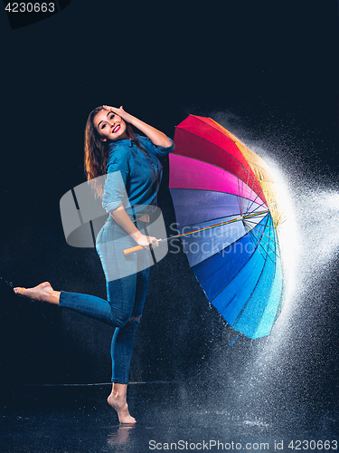 Image of Young beautiful woman with an umbrella.
