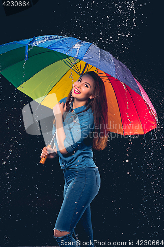 Image of Young beautiful woman with an umbrella.