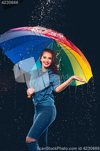 Image of Young beautiful woman with an umbrella.