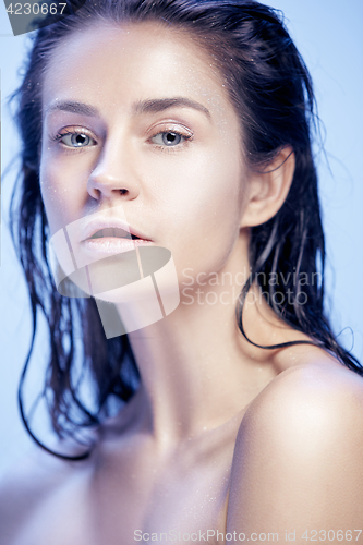 Image of Beautiful woman face portrait close up on blue