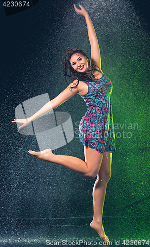 Image of Young beautiful woman under splash of rain