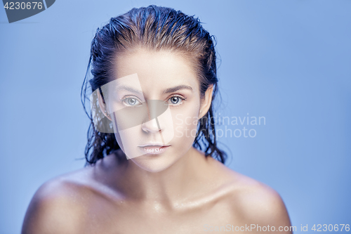 Image of Beautiful woman face portrait close up on blue