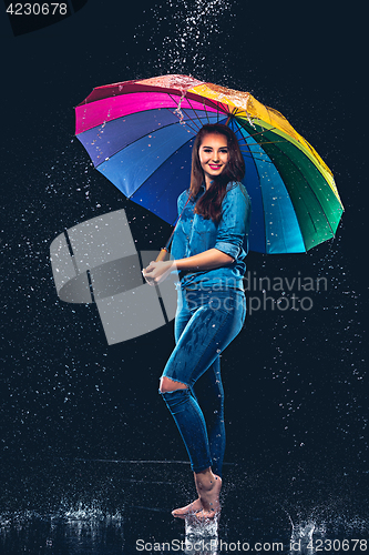Image of Young beautiful woman with an umbrella.