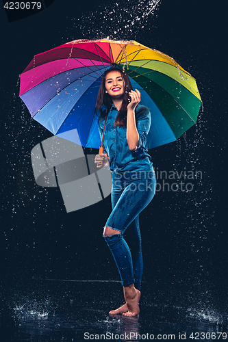 Image of Young beautiful woman with an umbrella.