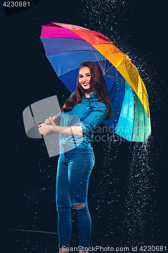 Image of Young beautiful woman with an umbrella.
