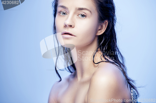 Image of Beautiful woman face portrait close up on blue