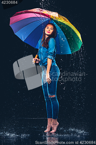 Image of Young beautiful woman with an umbrella.