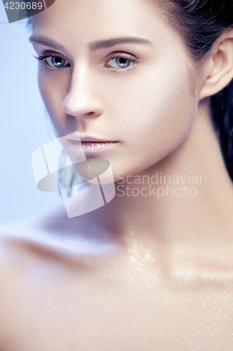 Image of Beautiful woman face portrait close up on blue