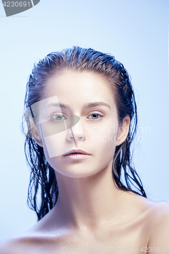 Image of Beautiful woman face portrait close up on blue