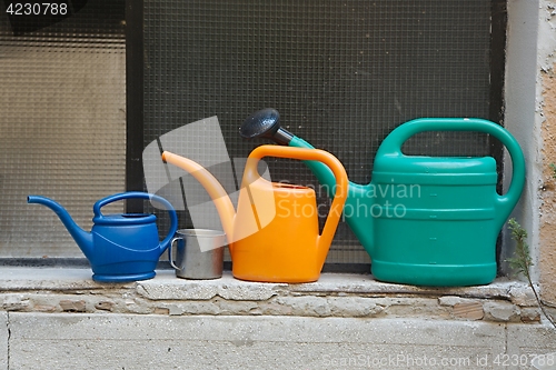 Image of Three watering cans